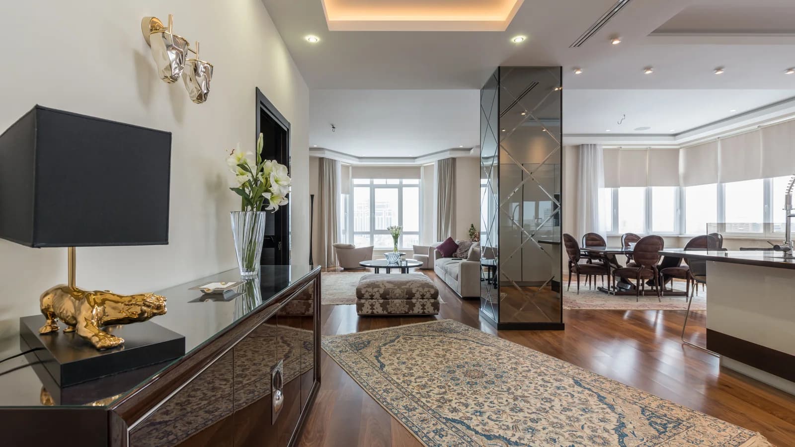 A light-filled luxury apartment living room and dining area.