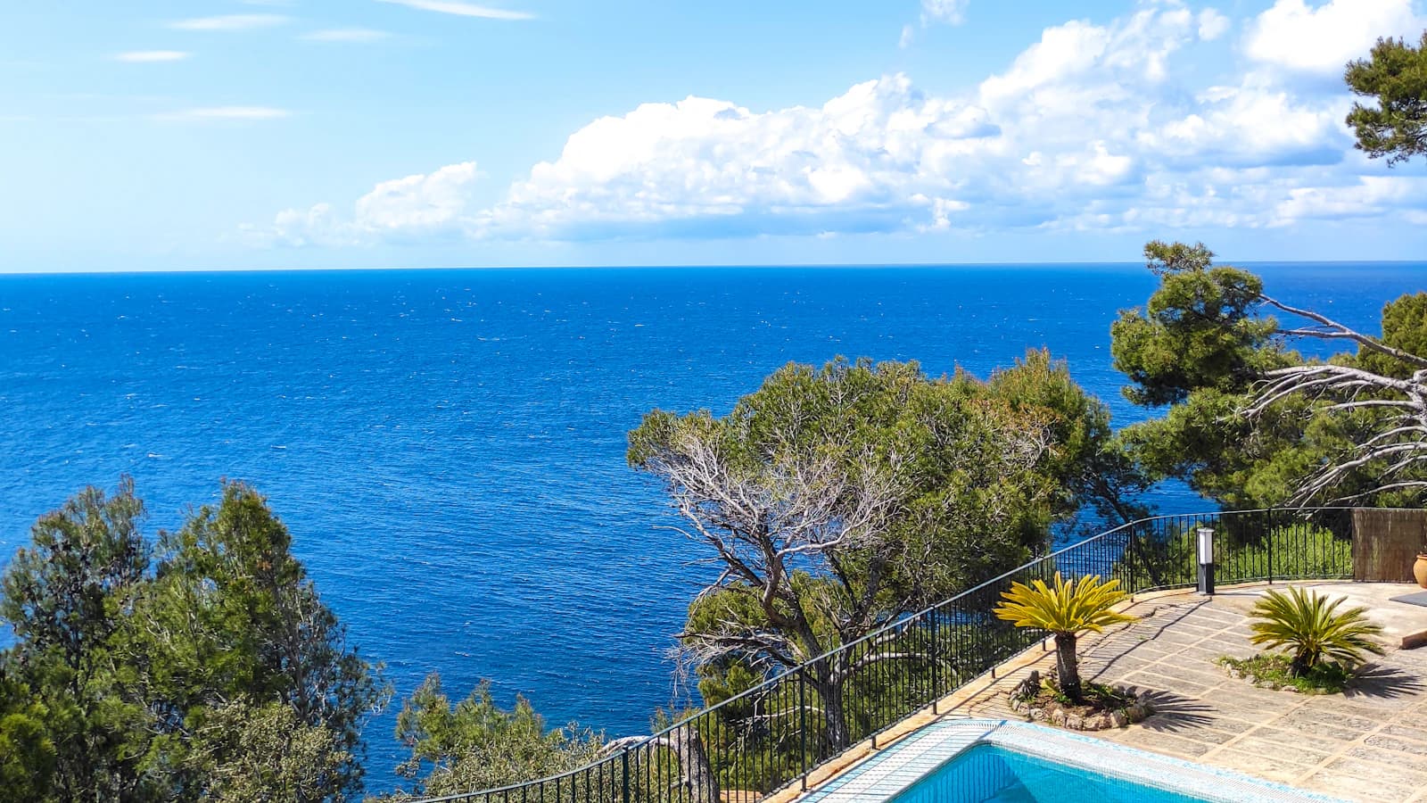 Luxury hillside pool terrace overlooking the blue Mediterranean Sea.